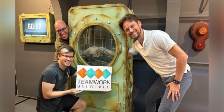 Brian and Tom posing in their escape room with the CEO of UseKase, Martin Gents